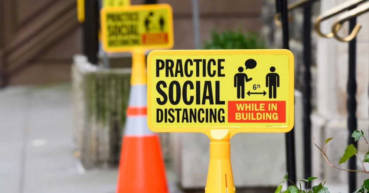 A sign that reads, "Practice social distancing," indicating a distance of 6 feet, sits outside the Stephen Wise Free Synagogue in New York City on Dec. 8.