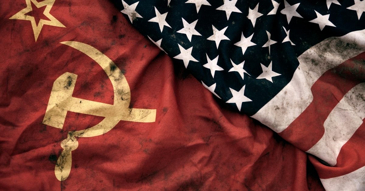 Photography of a grungy old Soviet Union and United States of America flags are pictured.