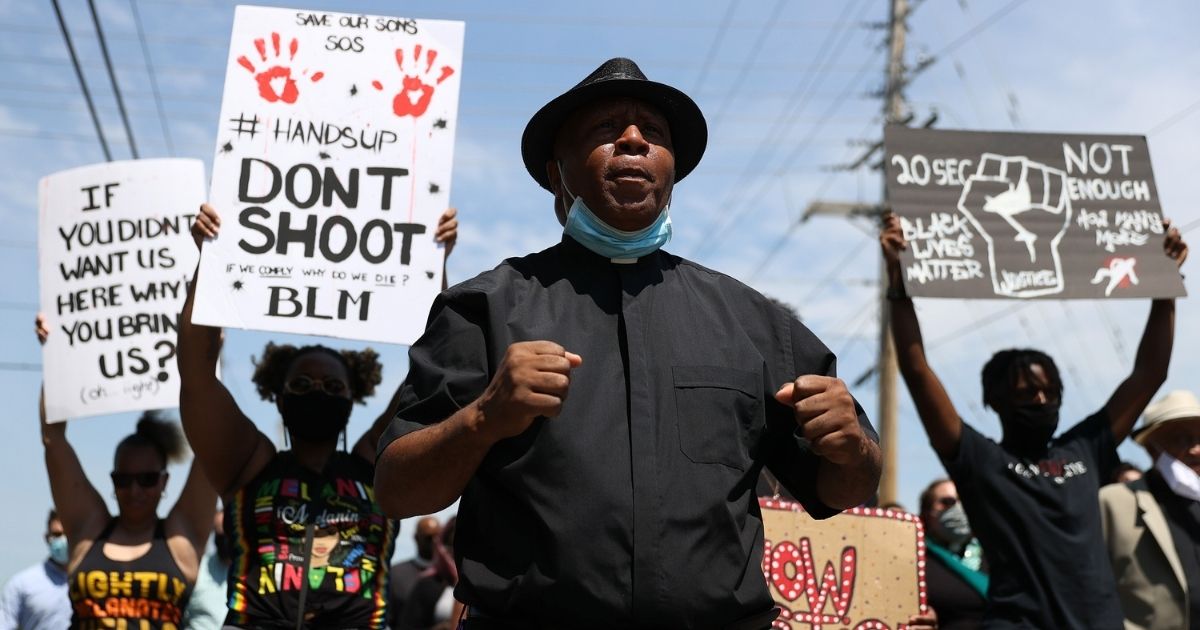 Rev. Tim Stallings joins with protesters as they walk to the spot where Andrew Brown Jr. was killed on Wednesday in Elizabeth City, North Carolina.