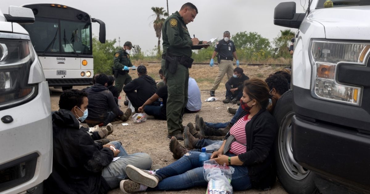 A U.S. Border Patrol agent registers immigrants Tuesday before they are taken to a processing center near the border in La Joya, Texas.