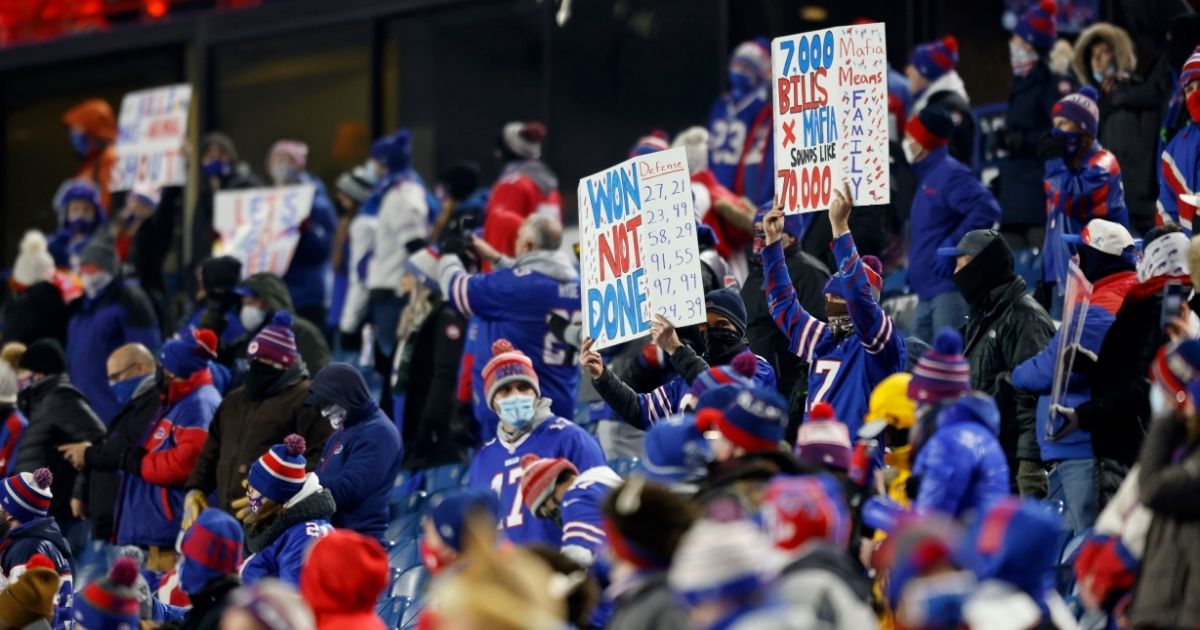 Fans hold signs prior to an AFC Divisional Playoff game between the Buffalo Bills and the Baltimore Ravens at Bills Stadium on Jan. 16, 2021, in Orchard Park, New York.