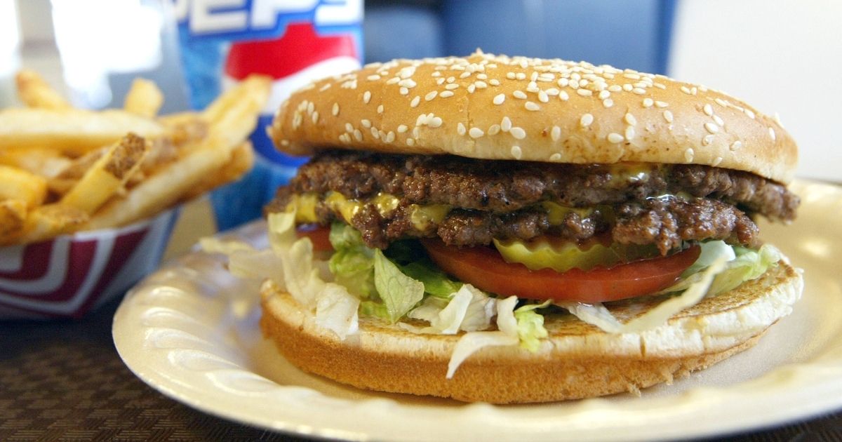A double cheeseburger, fries and soda lie on a table at Majors Hamburgers on Dec. 28, 2003, in Yakima, Washington.