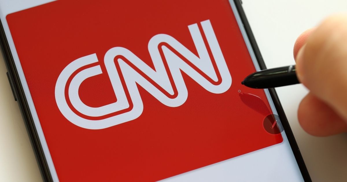 The CNN logo is pictured on a smartphone in the stock image above.