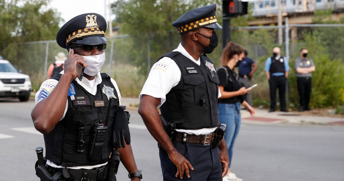 Chicago police officers monitor the area outside their District 7 headquarters during an anti-police demonstration in the city's Englewood neighborhood on Aug. 11.