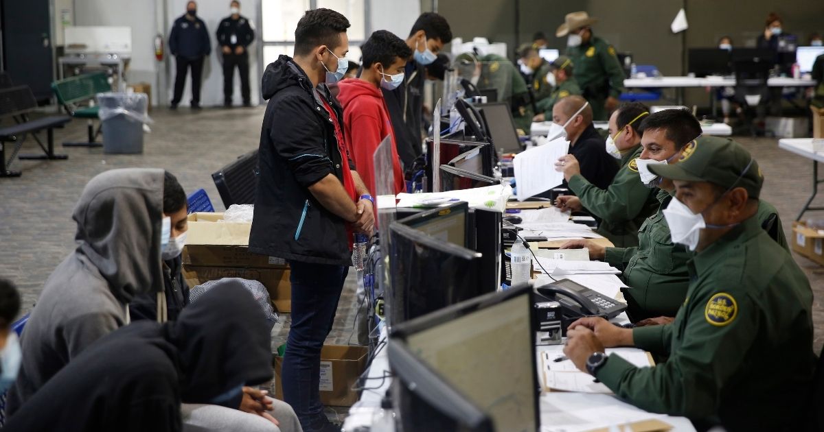 Migrants are processed at the intake area in the Department of Homeland Security holding facility run by the Customs and Border Patrol on March 30 in Donna, Texas.