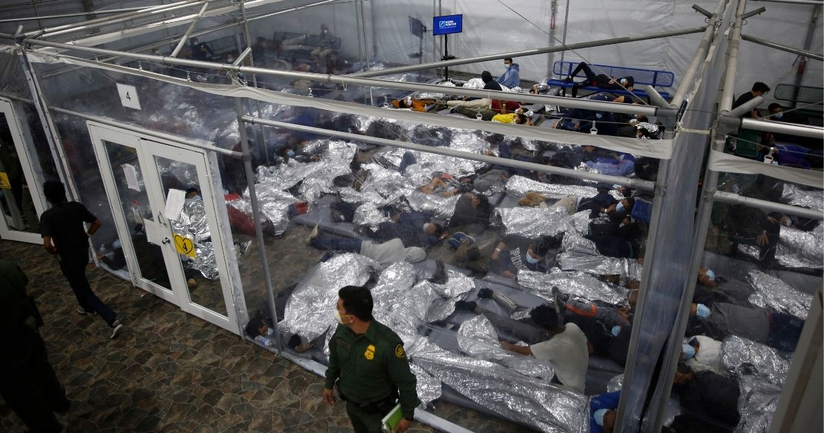 Migrant children lie close to one another inside a pod at the Department of Homeland Security holding facility run by the Customs and Border Patrol in Donna, Texas, on March 30.