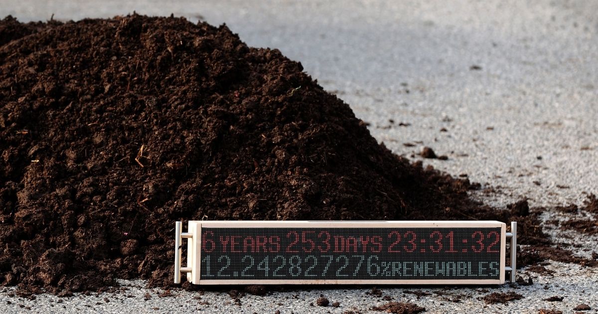 A countdown clock sits in a pile of manure left by activists outside the White House during a protest against President Joe Biden's climate change policy on Earth Day (Thursday) in Washington, D.C.
