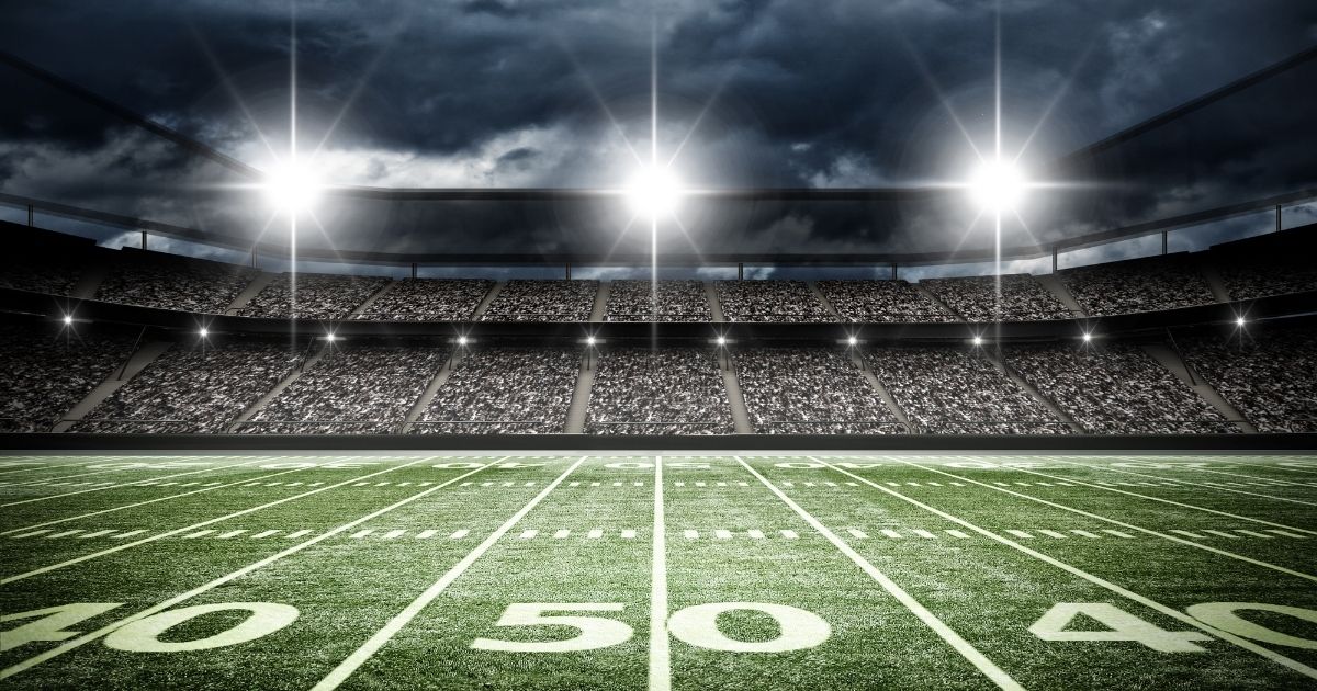 An American football stadium is pictured at night in the stock image above.