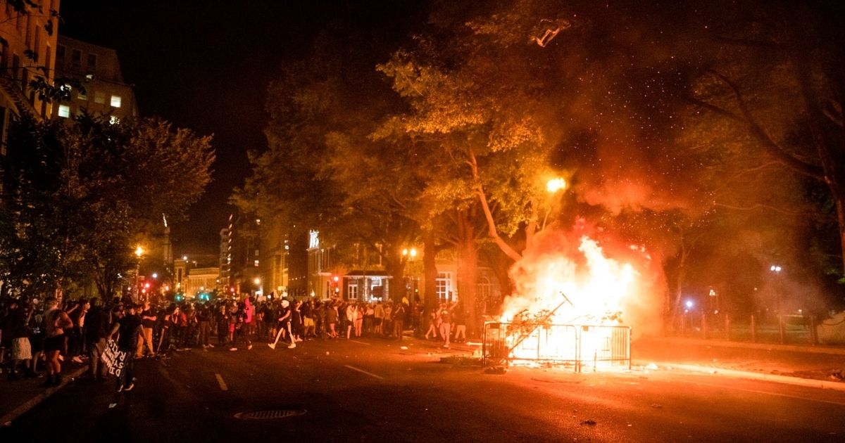 Protesters set a fire in the street a block from the White House while protesting the death of George Floyd in Washington, D.C., on May 31, 2020.