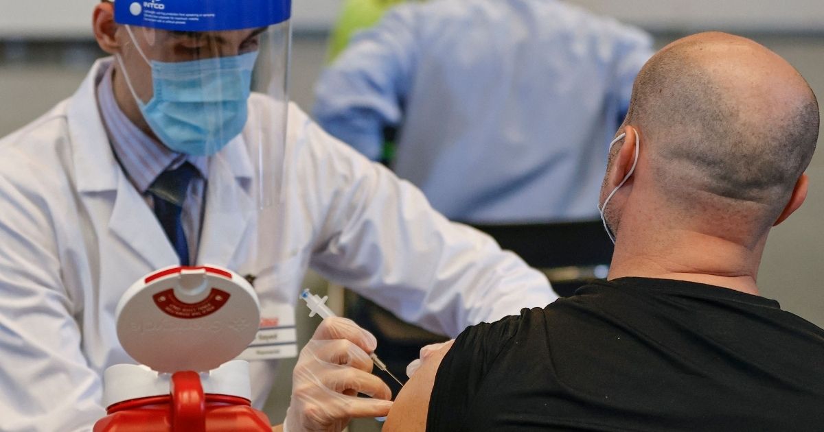 A man receives the Johnson & Johnson coronavirus vaccine at the International Union of Operating Engineers Local 399 union hall vaccination site in Chicago on April 6.
