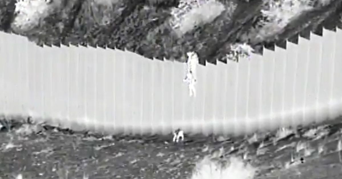 Two young children are dropped from the border wall into the U.S.