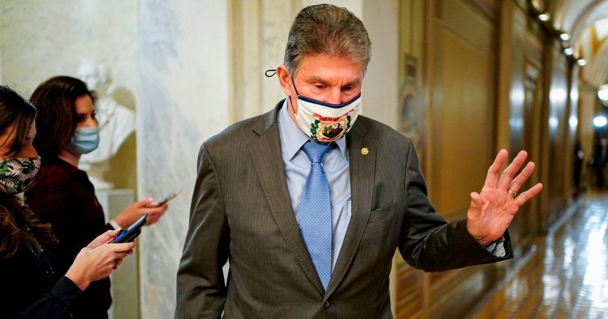 Democratic Sen. Joe Manchin of West Virginia walks through a hallway on Capitol Hill in Washington on Feb. 10.