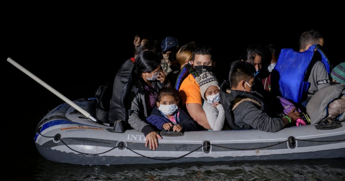 A 'coyote' people smuggler guides an inflatable boat carrying migrants from Central America arriving illegally from Mexico to the U.S. to seek asylum, on the Rio Grande river at the border city of Roma on March 29.