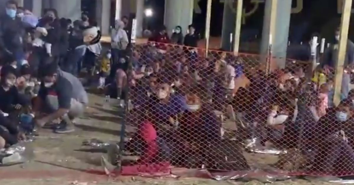 Conservative investigative reporter James O'Keefe released footage to Twitter on Thursday that seems to show a large number of migrants huddled underneath a bridge on the U.S.-Mexico border.