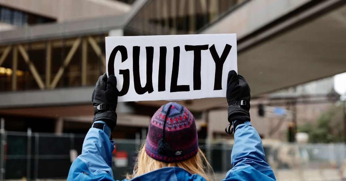 A protester holds a "guilty" sign outside a courthouse in Minneapolis on April 19, 2021.
