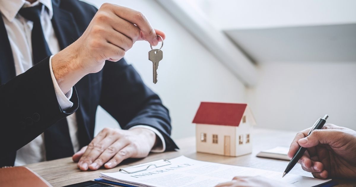 In the stock image above, a real estate agent is seen giving house keys to a client.