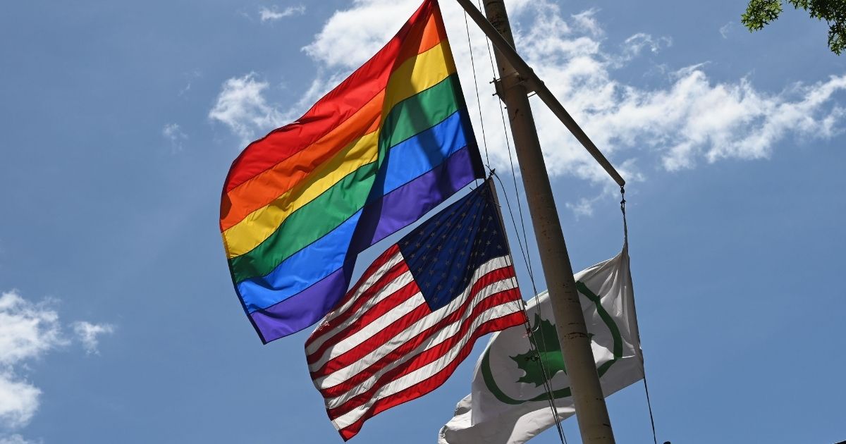 Pride flag above an American flag