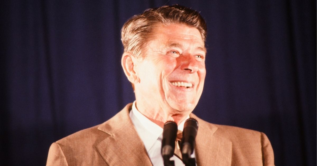 During his presidential campaign, Ronald Reagan smiles from behind a pair of microphones in Florida in June 1980.
