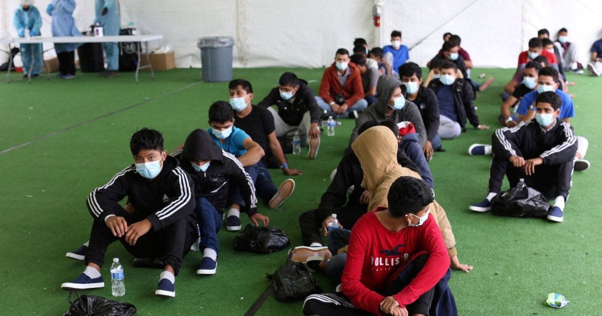 Young migrants wait to be tested for Covid-19 at the Donna Department of Homeland Security holding facility, the main detention center for unaccompanied children in the Rio Grande Valley in Donna, Texas, on March 30.