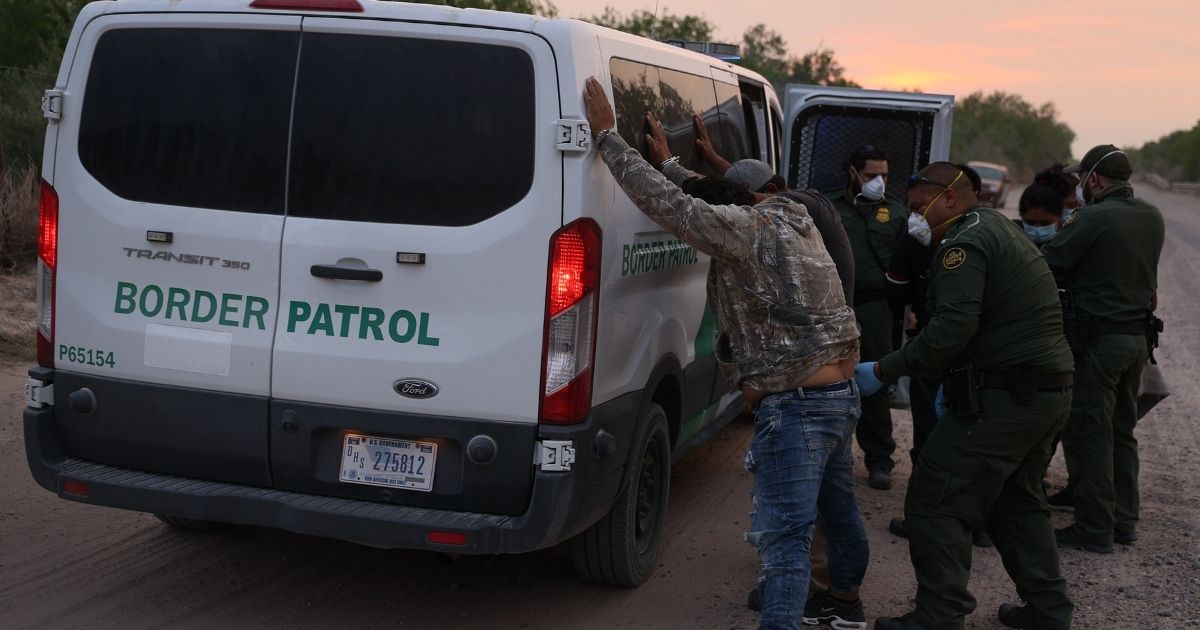 Border Patrol agents frisk a group of illegal aliens caught crossing the border from Mexico on March 27 in Penitas, Texas. 