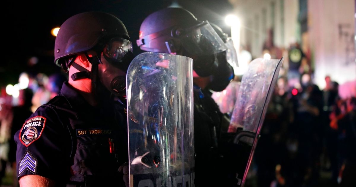 Police in riot gear face down rioters during violent demonstrations in August in Kenosha, Wisconsin, over the shooting of a domestic abuse suspect by Kenosha police Officer Rusten Sheskey.