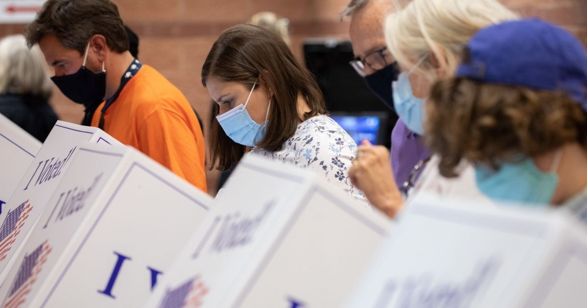 Voters cast their ballots in the voting booths at the early vote location at the Charleston Coliseum and Convention Center in North Charleston, South Carolina, on Oct. 16, 2020.