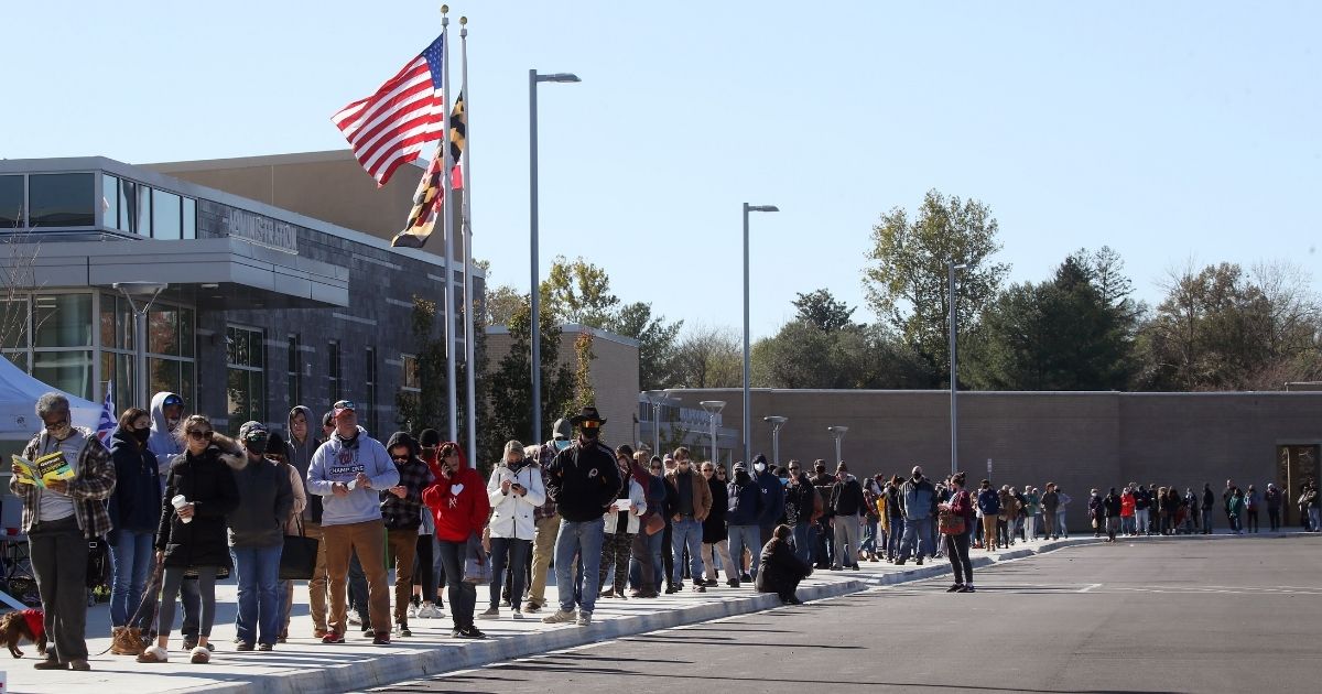 People wait in line to cast their votes at Northern High School, on Nov. 3, 2020, in Owings, Maryland.