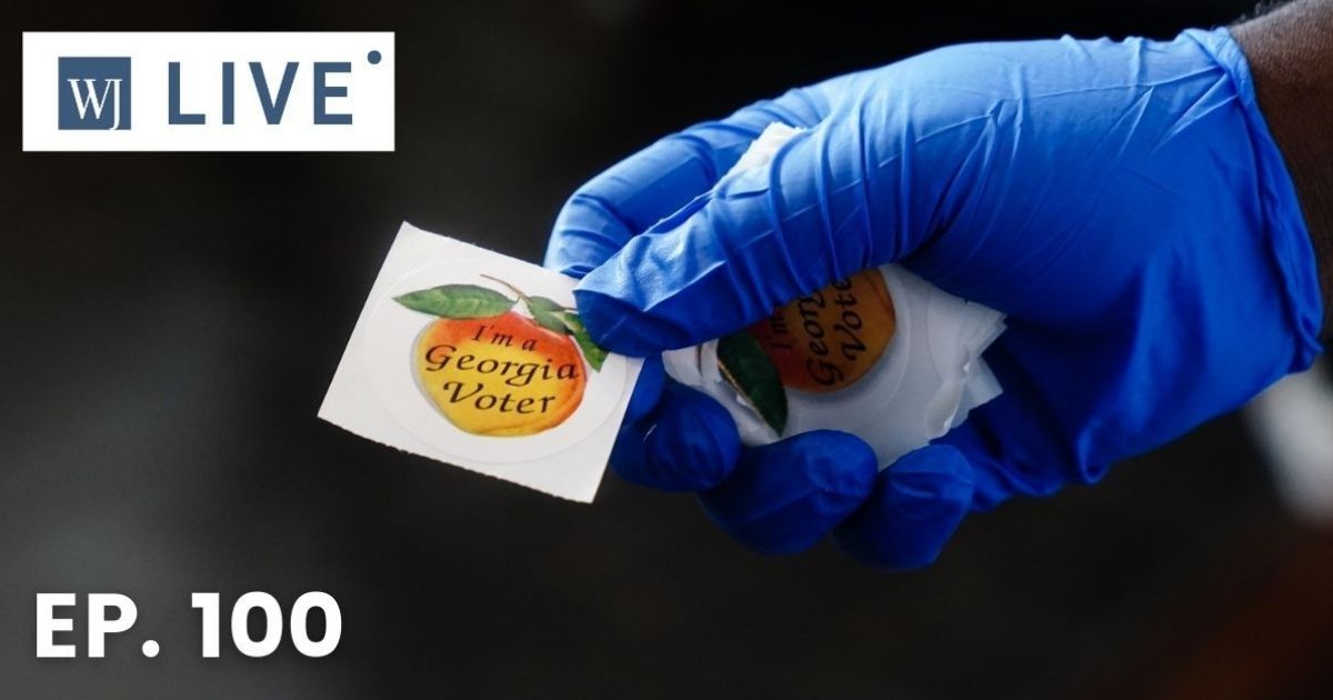 A polling place worker holds an "I'm a Georgia Voter" sticker to hand to a voter on June 9, 2020, in Atlanta.