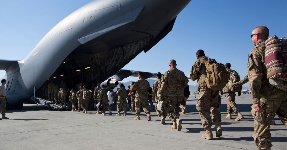 US Army soldiers walk to their C-17 cargo plane for departure on May 11, 2013, at Bagram Air Base, Afghanistan.
