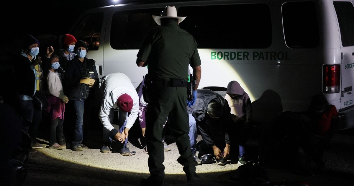 A group of illegal migrants is processed by U.S. Border Patrol agents after arriving from Mexico on March 30, 2021, in Roma, Texas.