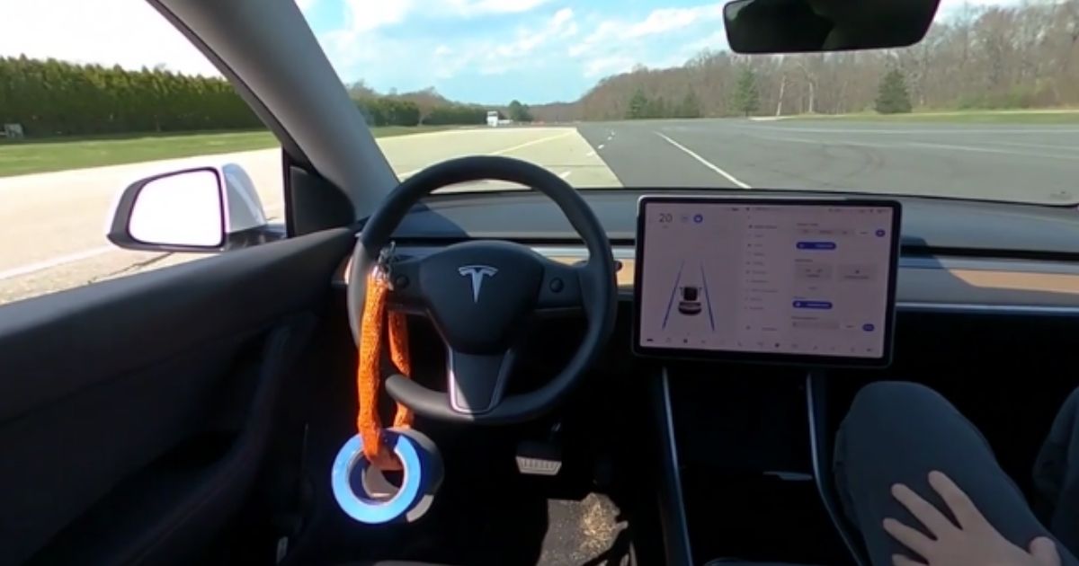 A Tesla Model Y drives without anyone in the driver's seat in this image taken from video.