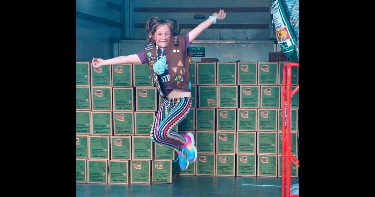 Lilly Bumpus shows off the 5,000 boxes of donated cookies she was able to deliver to kids fighting childhood cancer.