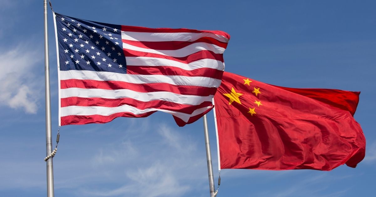 The American and Chinese flags fly in this stock image.