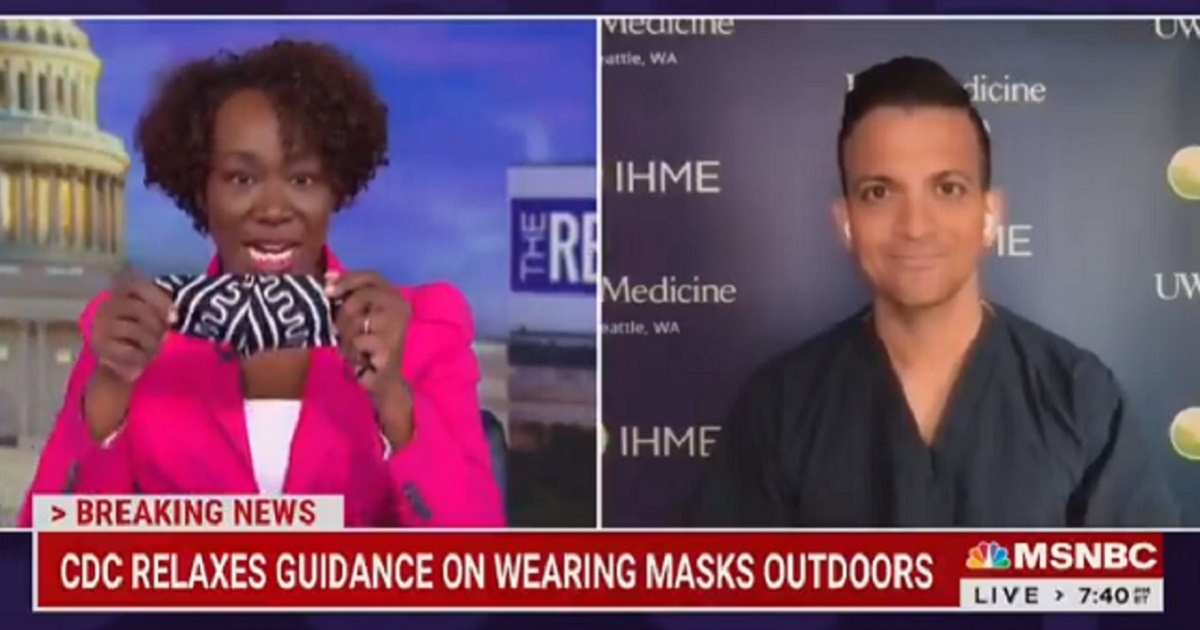 MSNBC's Joy Reid shows off her mask on television Tuesday.