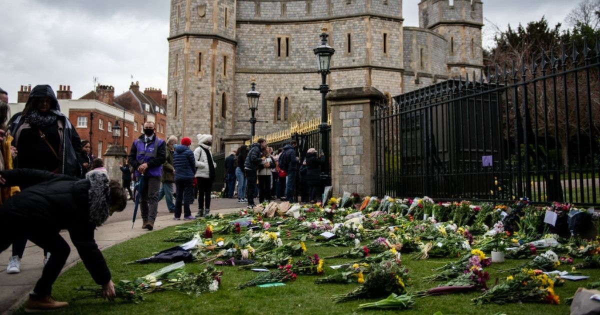 People leave floral tributes to Prince Philip on April 10, 2021, at Windsor Castle in Windsor, United Kingdom.