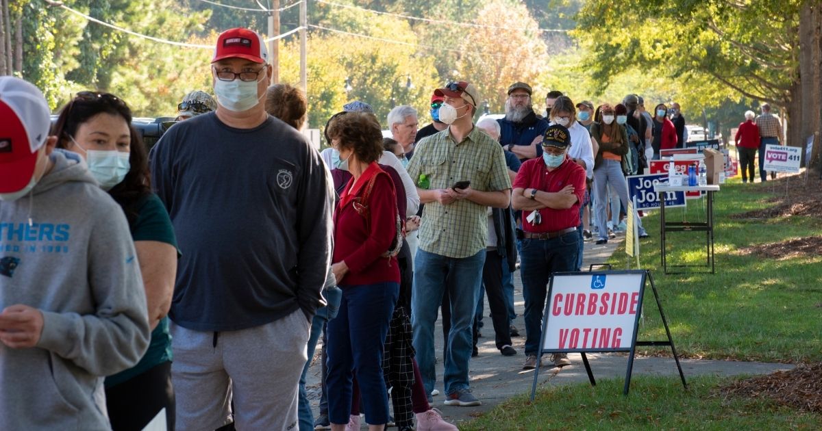 Voters wait in line in the above stock image.