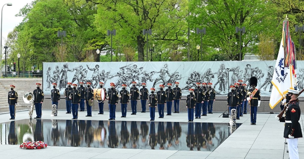 The United States Army Band and members of the Joint Armed Forces Color Guard appear at the World War I Memorial on April 16, 2021, in Washington, D.C.