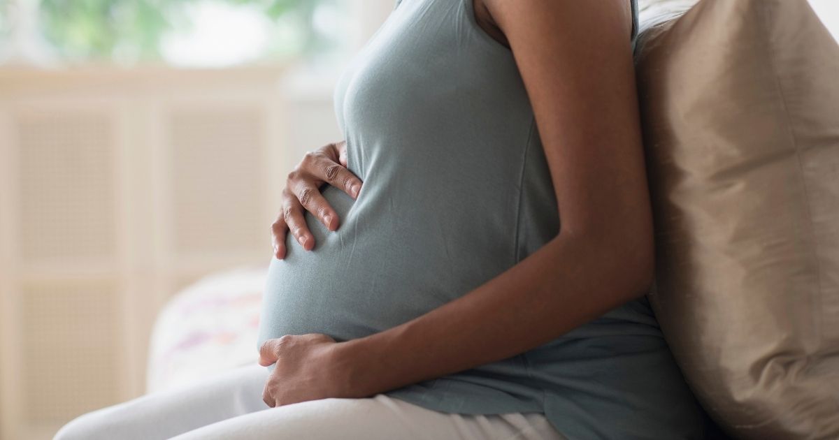 A pregnant woman is seen in this stock image.
