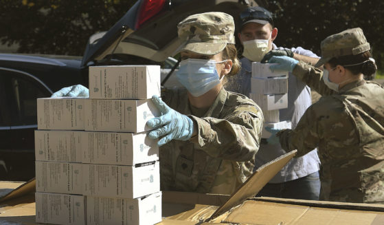 Oregon National Guard member Ashley Smallwood counts out boxes of face masks to be given to farmers in Tangent, Oregon, on May 27, 2020.
