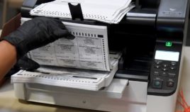 An election worker scans mail-in ballots at the Clark County Election Department in North Las Vegas, Nevada, on Nov. 7.