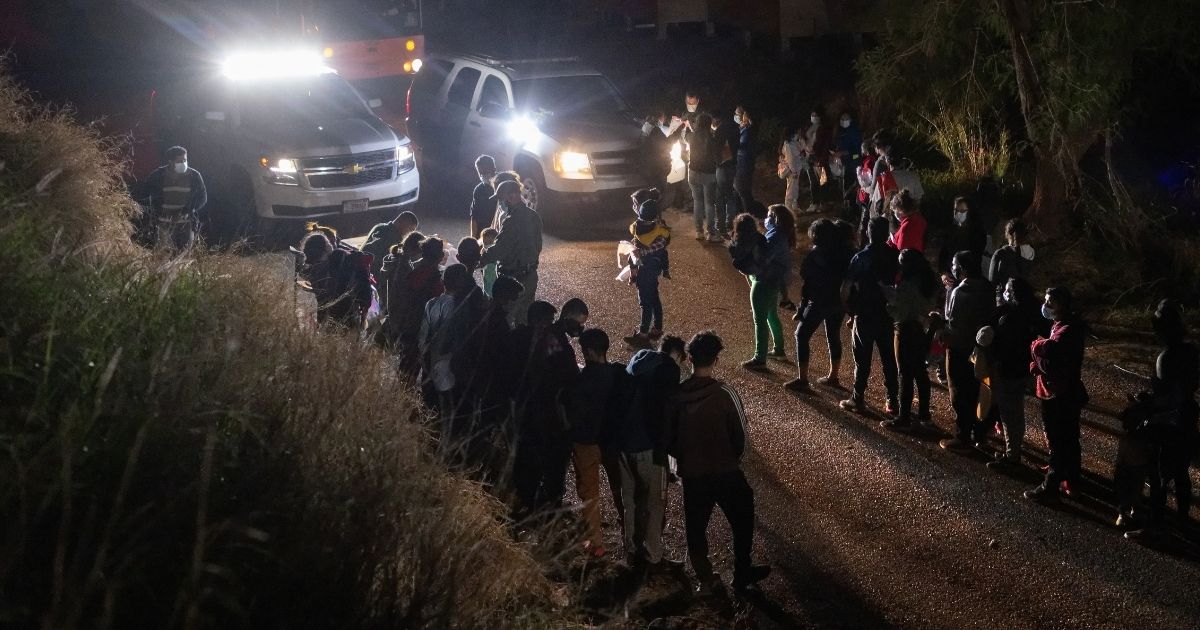 U.S. Border Patrol agents process immigrant families after they crossed the Rio Grande into south Texas on Thursday in Roma, Texas.