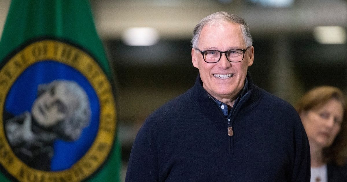 Democratic Washington State Gov. Jay Inslee and other leaders speak to the press on March 28, 2020, in Seattle.