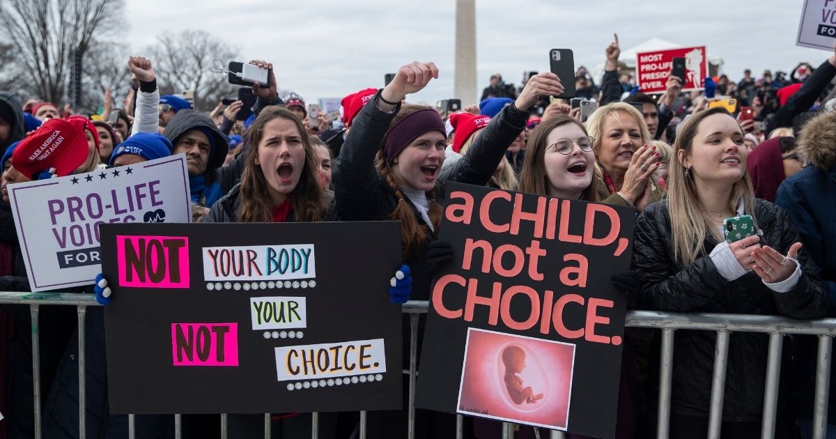 Pro-life protesters hold signs during the annual "March for Life" rally on the National Mall in Washington on Jan. 24, 2020.