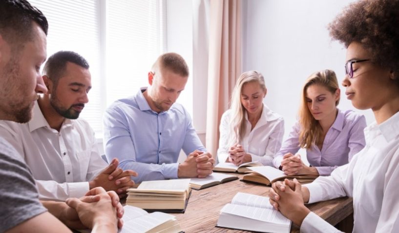 People are pictured praying in the stock image above.