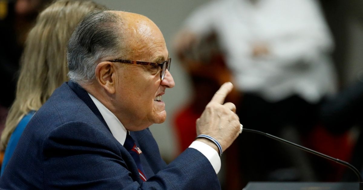 Rudy Giuliani gestures as he speaks during an appearance before the Michigan House Oversight Committee in Lansing, Michigan, on Dec. 2, 2020.