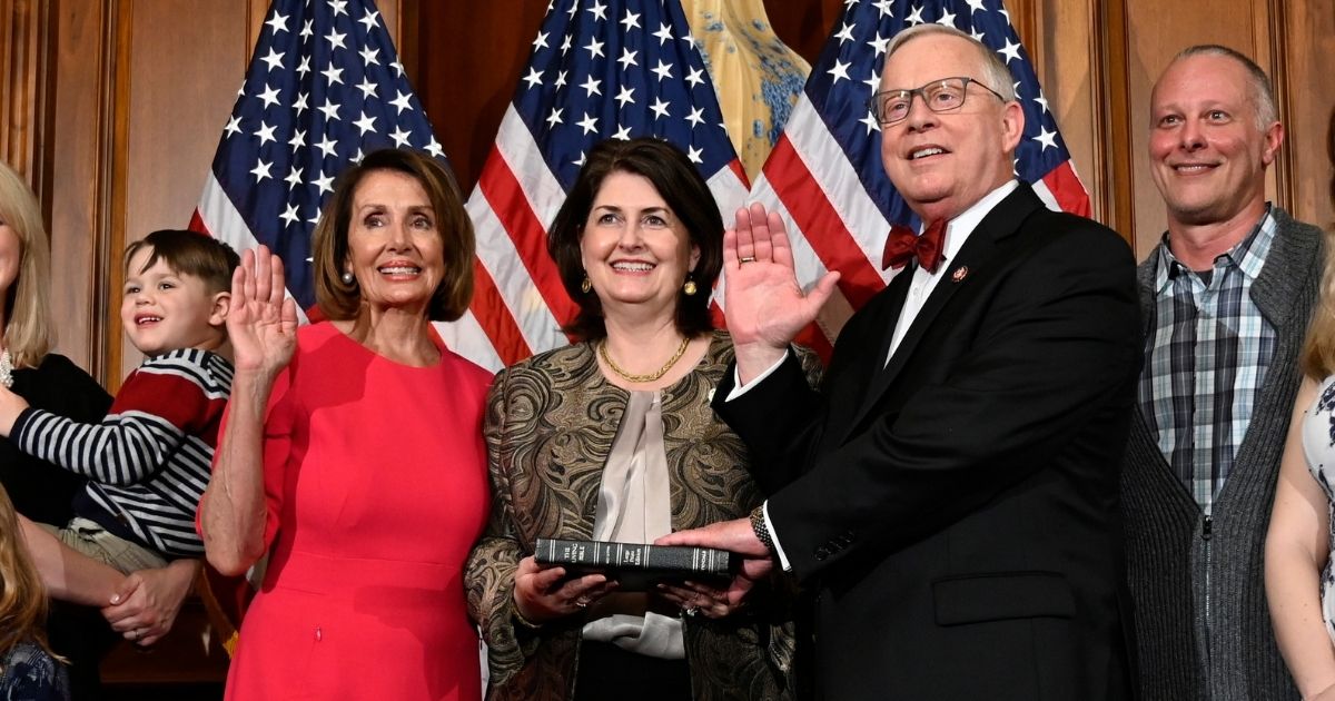 Democratic House Speaker Nancy Pelosi poses during a ceremonial swearing-in with Republican Rep. Ron Wright of Texas and his wife, Susan Wright, on Capitol Hill in Washington during the opening session of the 116th Congress on Jan. 3, 2019.