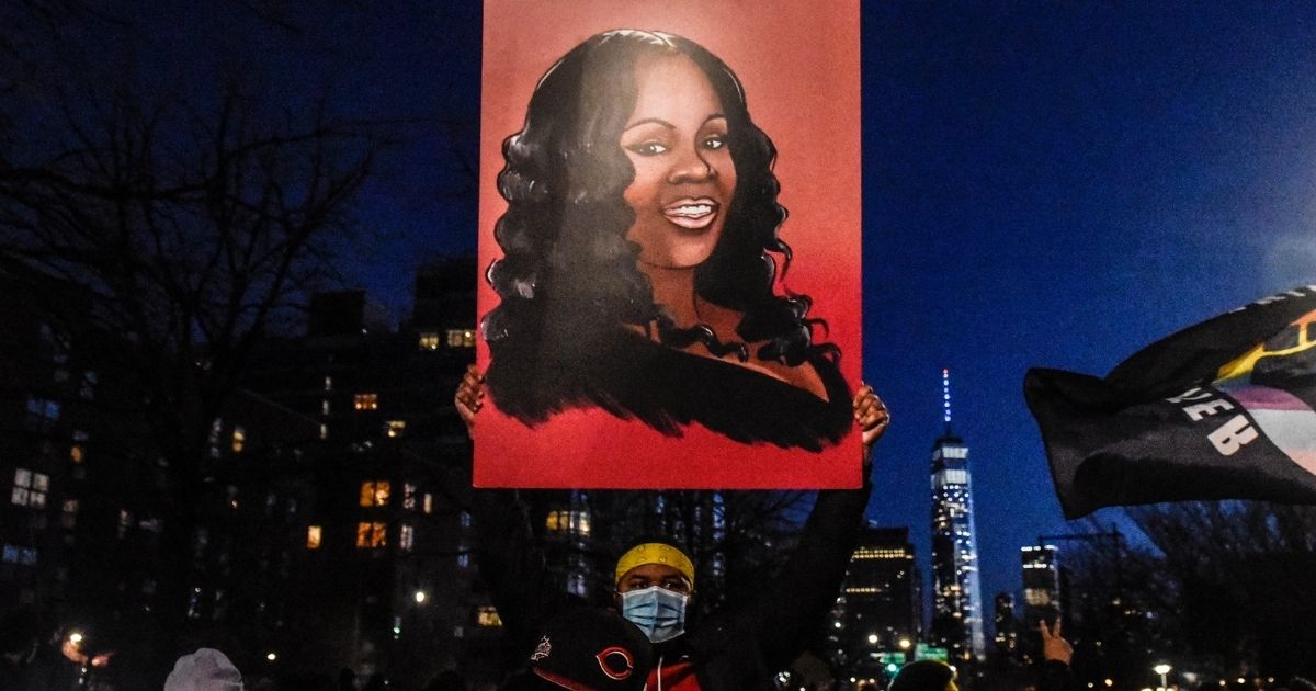 Marchers in New York City hold an image of Breonna Taylor during a March 13 demonstration.