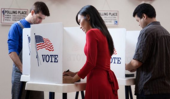 The above stock photo shows voters filling out their ballots.