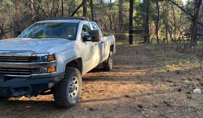 A Colorado Parks and Wildlife truck in Colorado, near a caution-taped area. A woman was found dead Friday after going for a walk with her dog.