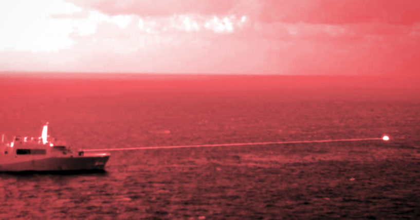 In this handout infrared photo from the U.S. Marine Corps, the USS Portland fires a laser weapon system at a target floating in the Gulf of Aden on Tuesday. The U.S. Navy announced Wednesday that it tested a laser weapon and destroyed a floating target in the Middle East.